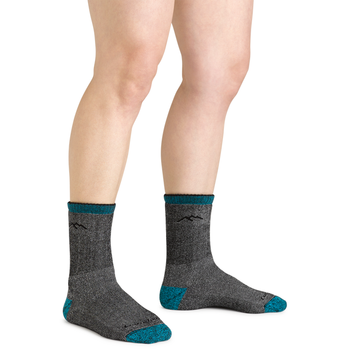 Close up shot of model wearing the women's mountaineering micro crew hiking socks in midnight with no shoes on