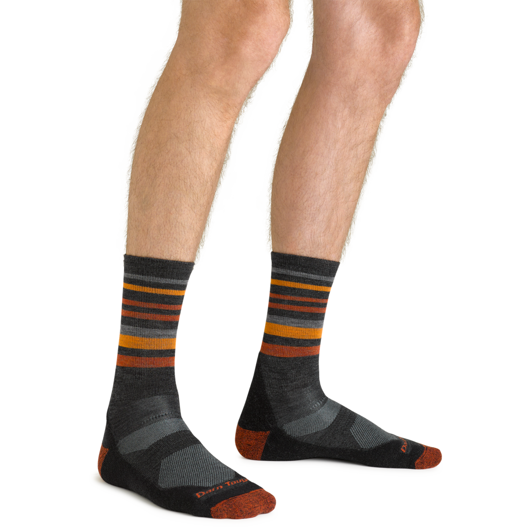 Close up shot of model wearing the men's fastpack micro crew hiking socks in charcoal with no shoes on