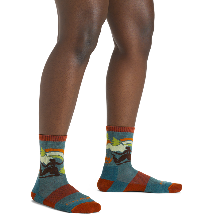 Image of a woman's legs on a white background wearing Women's trailblazer Micro Crew Lightweight Hiking Socks in teal colorway