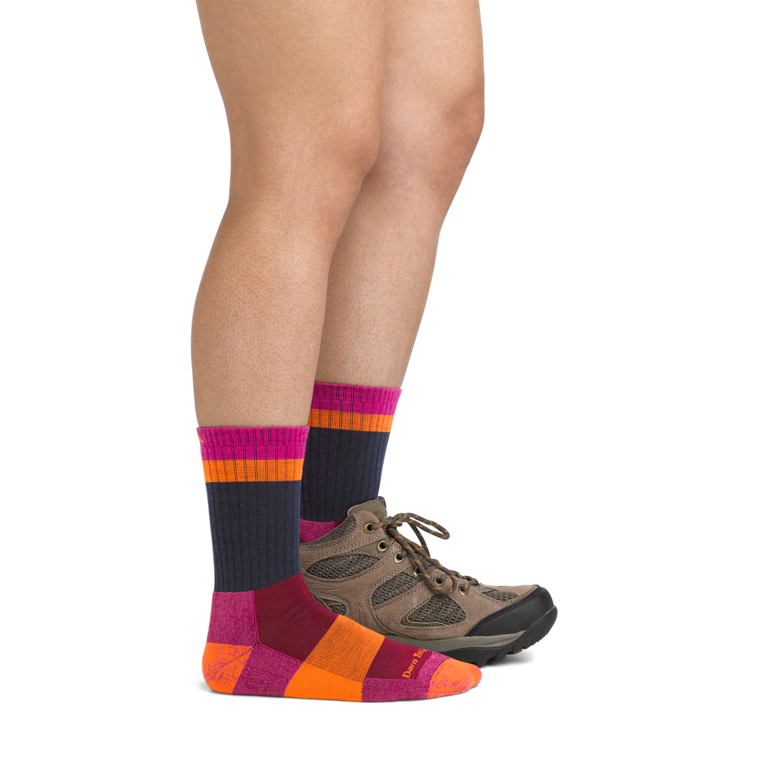 Image of model wearing 5018 Heady Betty Hiking Socks in Clover colorway and brown hiking boot on one foot