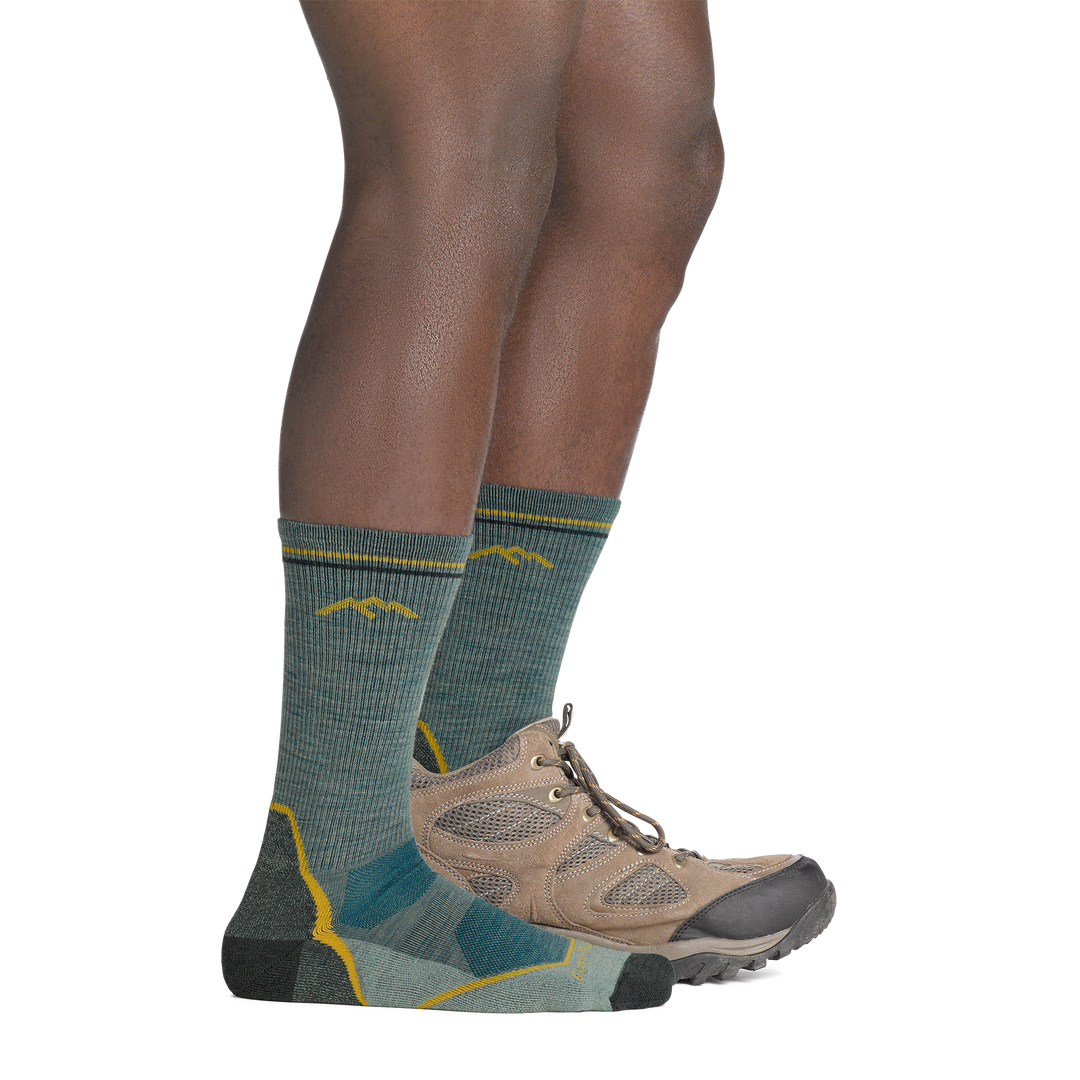 on model image with back foot in hiking shoe wearing the 5028 light hiker boot sock in seafoam green colorway