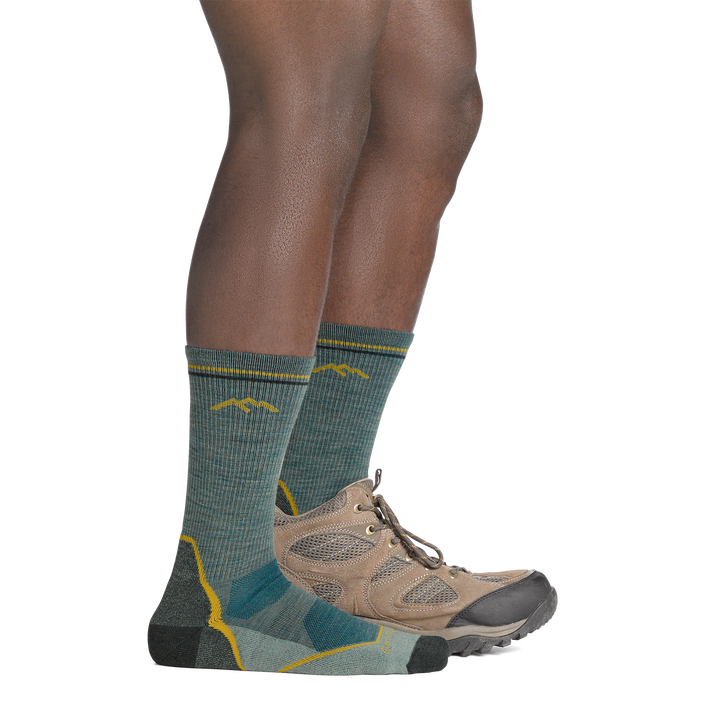 on model image with back foot in hiking shoe wearing the 5028 light hiker boot sock in seafoam green colorway