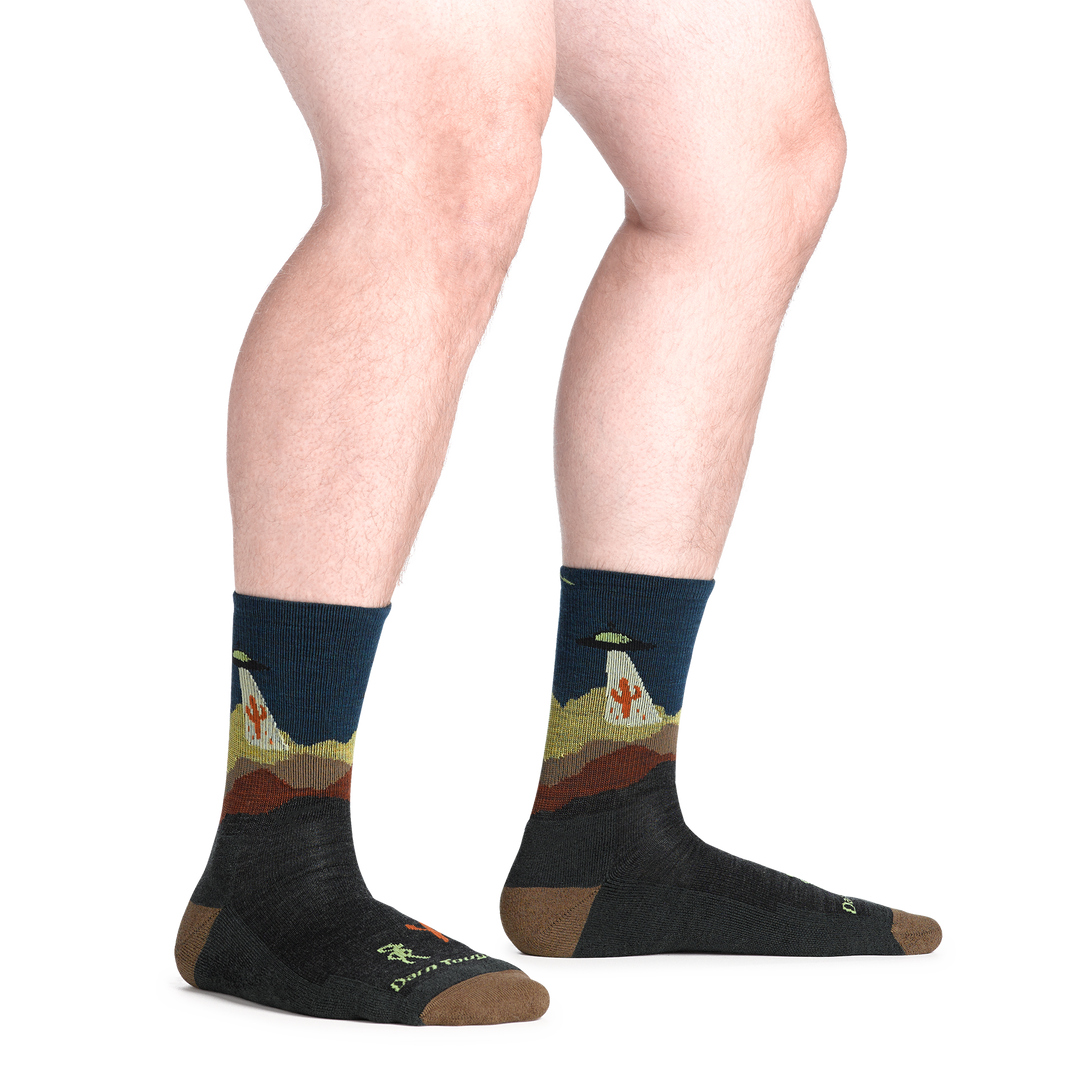 model standing barefoot wearing the 5051 spaced out micro crew hiking sock in charcoal colorway