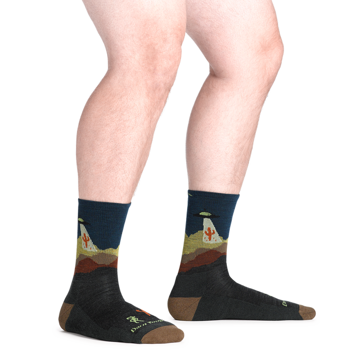 model standing barefoot wearing the 5051 spaced out micro crew hiking sock in charcoal colorway