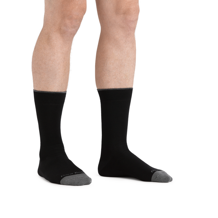 Close up image of man barefoot, wearing Solid Crew Lightweight Lifestyle sock in Black