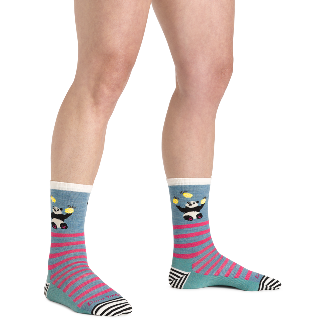 Close up shot of model wearing the women's animal haus crew lifestyle sock in Lagoon with no shoes on
