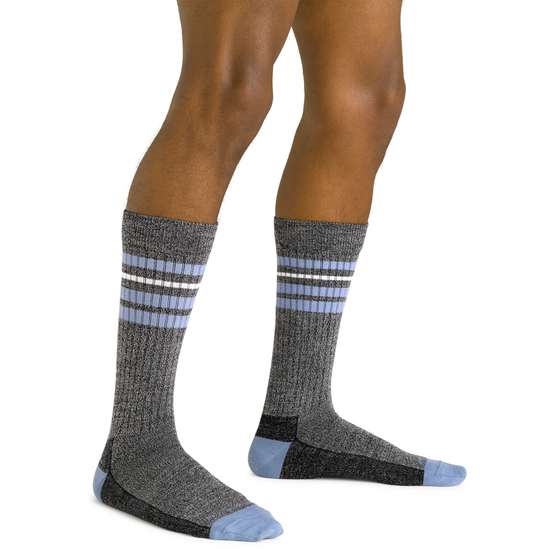 Close up shot of model wearing the men's letterman crew lifestyle sock in granite with no shoes on