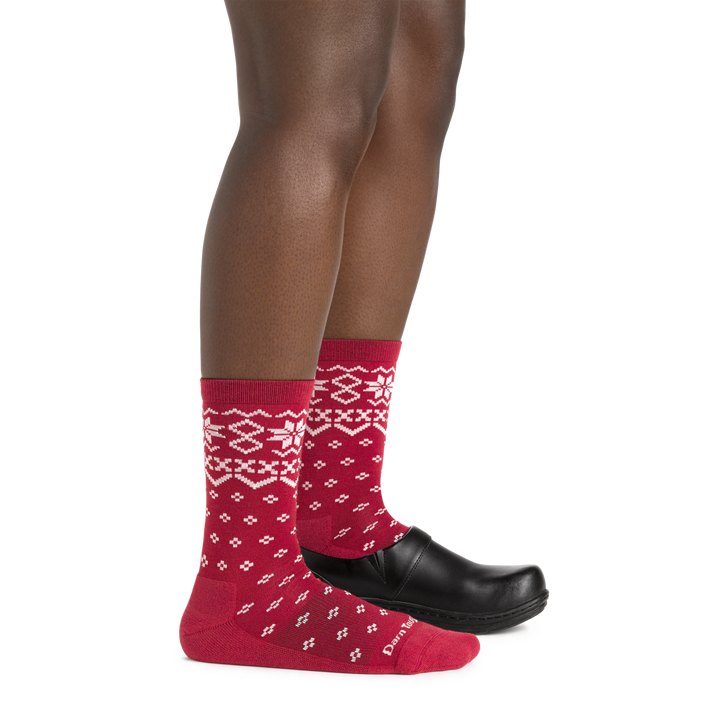 Side studio shot of model wearing women's shetland crew lightweight lifestyle sock in cranberry with black show on left foot