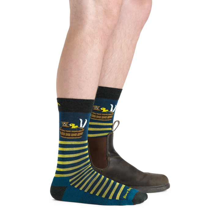 Side shot of model wearing the men's wild life crew lifestyle socks in Dark teal with a brown shoe on his left foot