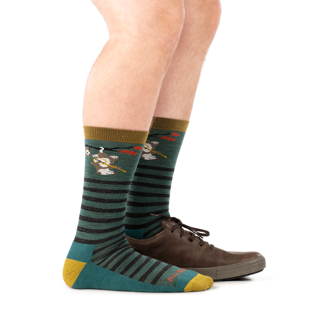 model wearing shoe on back foot and 6096 fox teal crew lightweight with cushion sock side profile