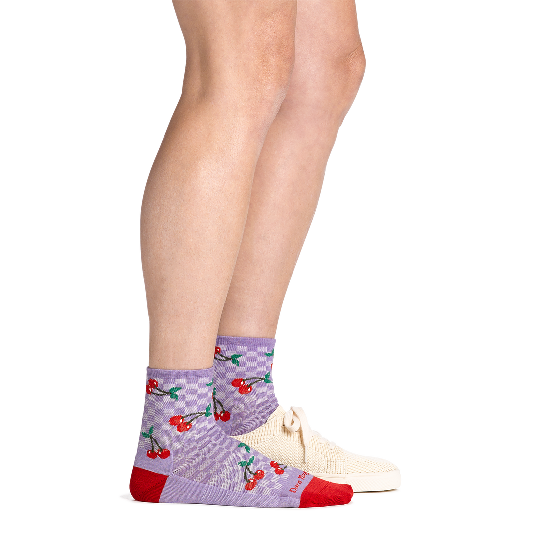 On model image with back foot in flat shoe wearing the 6102 fruit stand shorty lifestyle sock in cherry lavender colorway