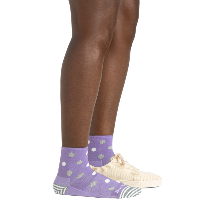 Model wearing the women's dottie shorty lifestyle socks in lavender with a black shoe on her left foot