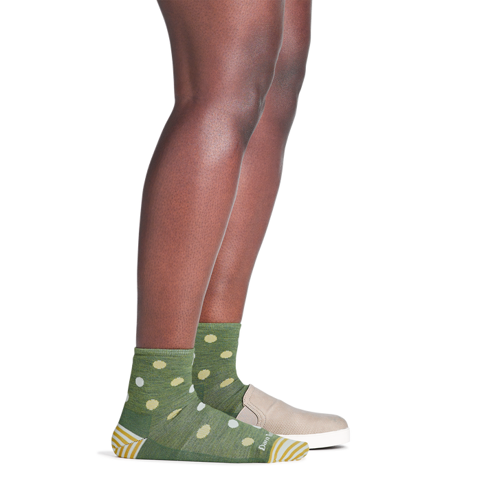 on model image with back foot in loafer wearing the 6103 dottie shorty lifestyle sock in willow green colorway