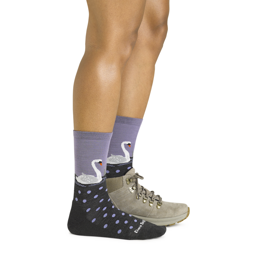 Side shot of model wearing the women's wild life crew lifestyle socks in charcoal with a gray boot on her left foot