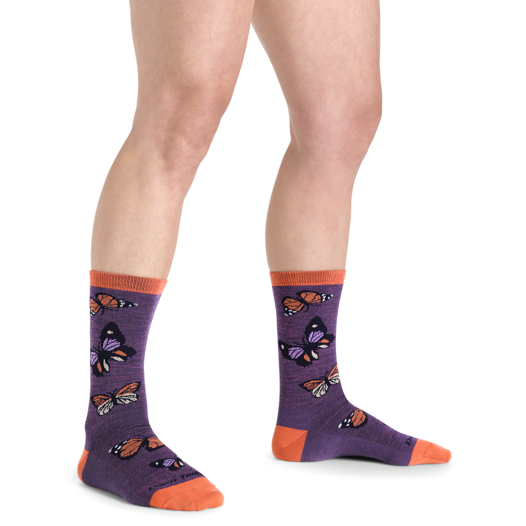 Close up studio shot of model wearing women's flutter crew lightweight lifestyle sock in plum