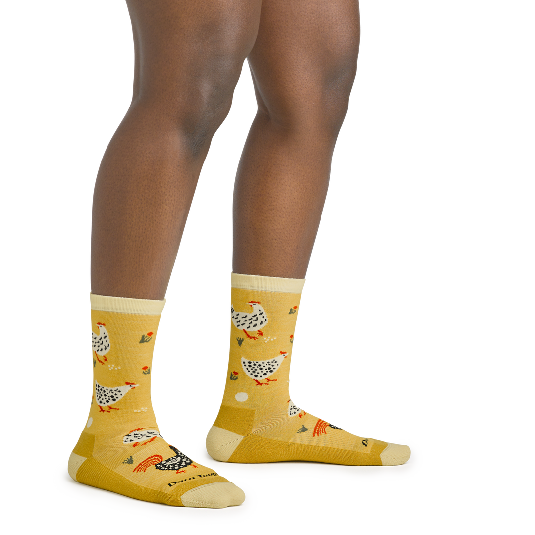 On model image of 6114 Mother Clucker Lifestyle socks in Sunny colorway featuring yellow body and white and black chickens