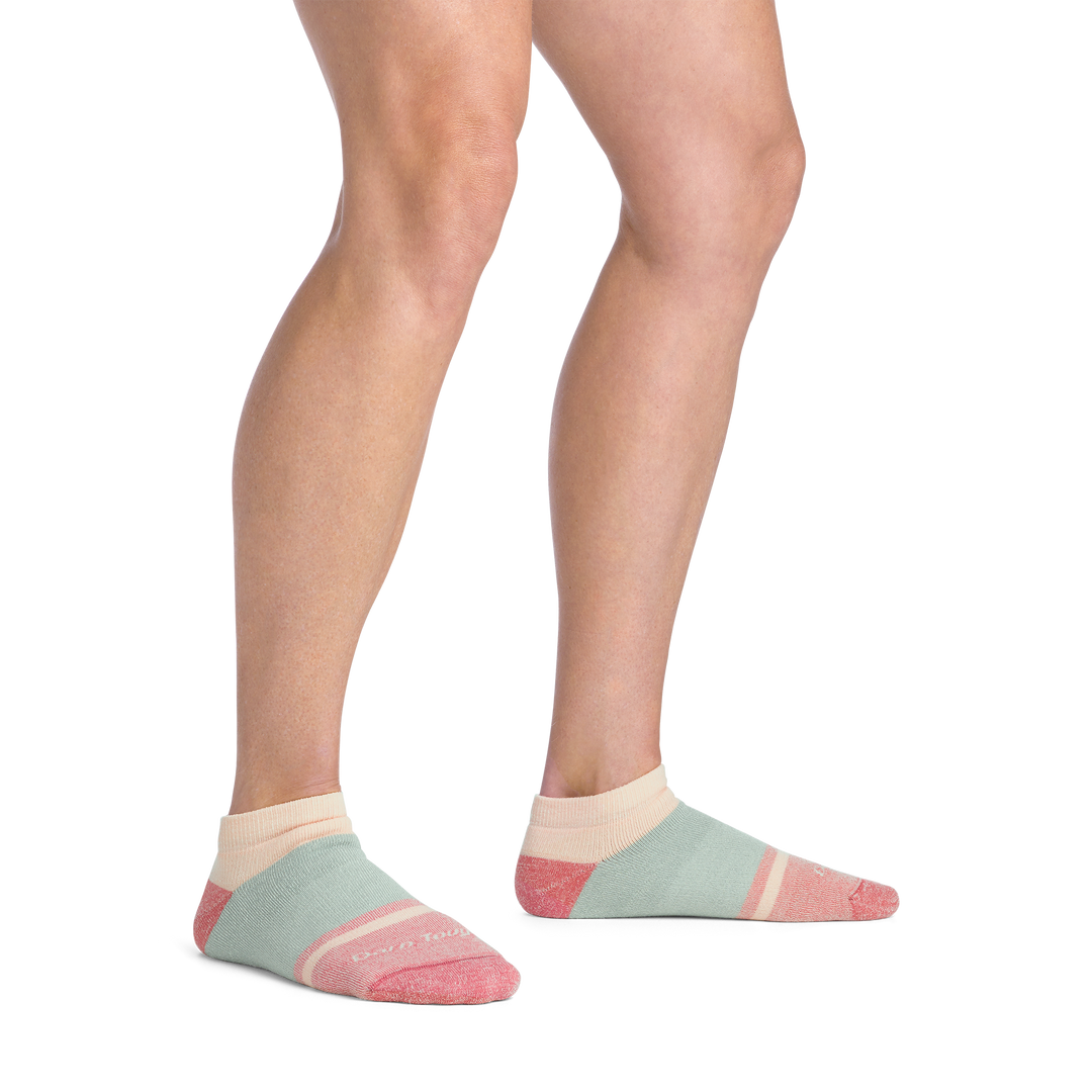 on model image bare foot wearing the 6127 no show lifestyle sock in honeydew colorway