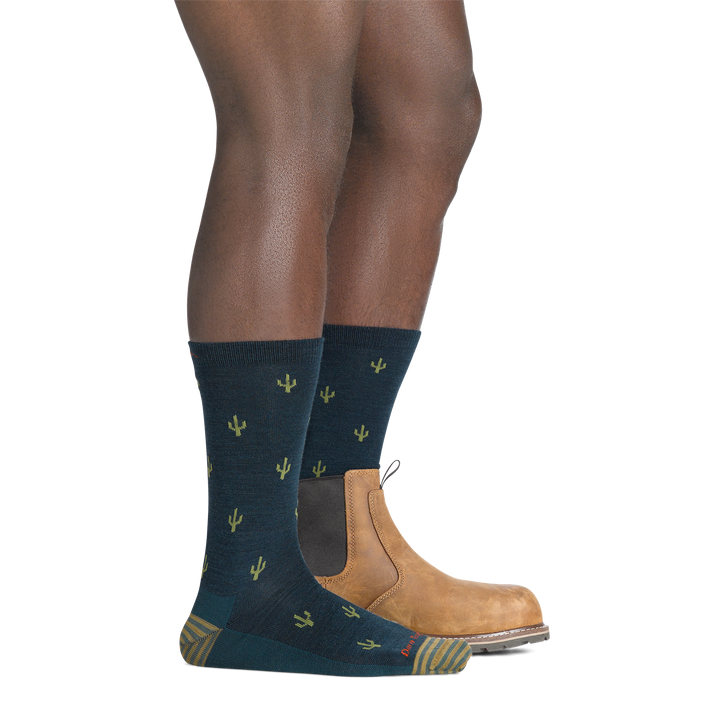 on model image with back foot in low cut boot wearing the 6132 wool'd wool'd west lifestyle crew sock in dark teal colorway