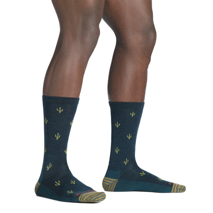 model standing barefoot wearing the 6132 wool'd wool'd west lifestyle crew sock in dark teal colorway