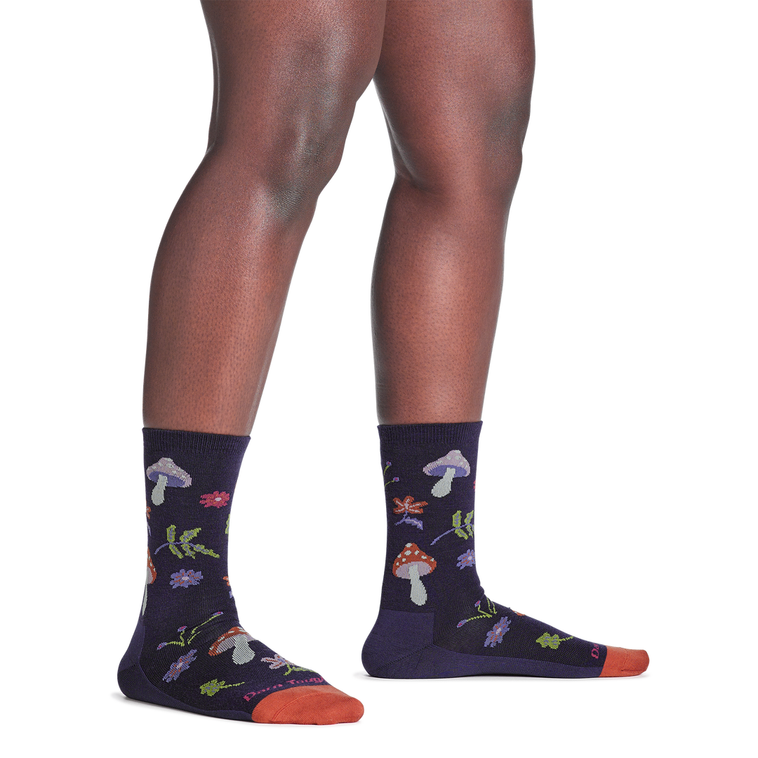 model standing barefoot wearing the 6133 shroom bloom lifestyle crew sock in blackberry colorway