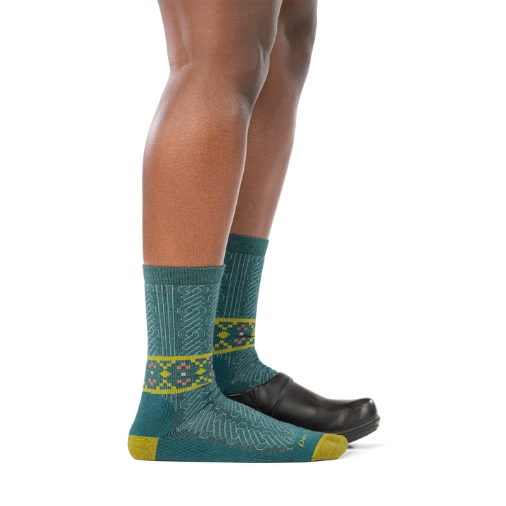 model wearing clog on back foot and 6141 teal lightweight crew with cushion sock on front foot side profile