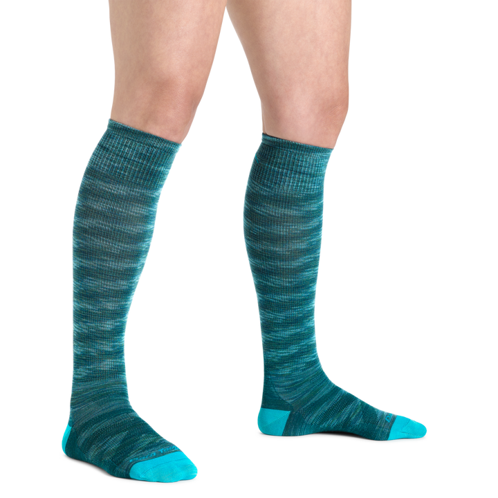 Image of a woman's legs on a white background wearing Women's RFL Over the Calf Ultra-Lightweight Ski & Snowboard Socks in Neptune