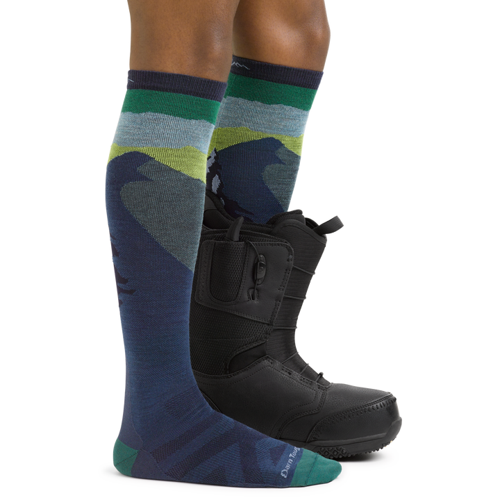 Men's Solstice Snowboard and Ski Socks in Midnight blue on foot with boot