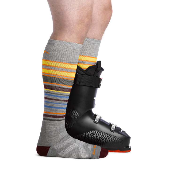 Men's Snowpack Snowboard and Ski Socks in Gray on foot with ski boot on back foot