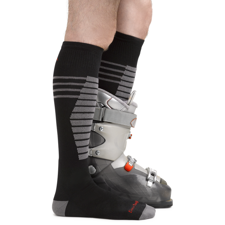 Men's Edge Snowboard and Ski Socks in Black on foot with ski boots