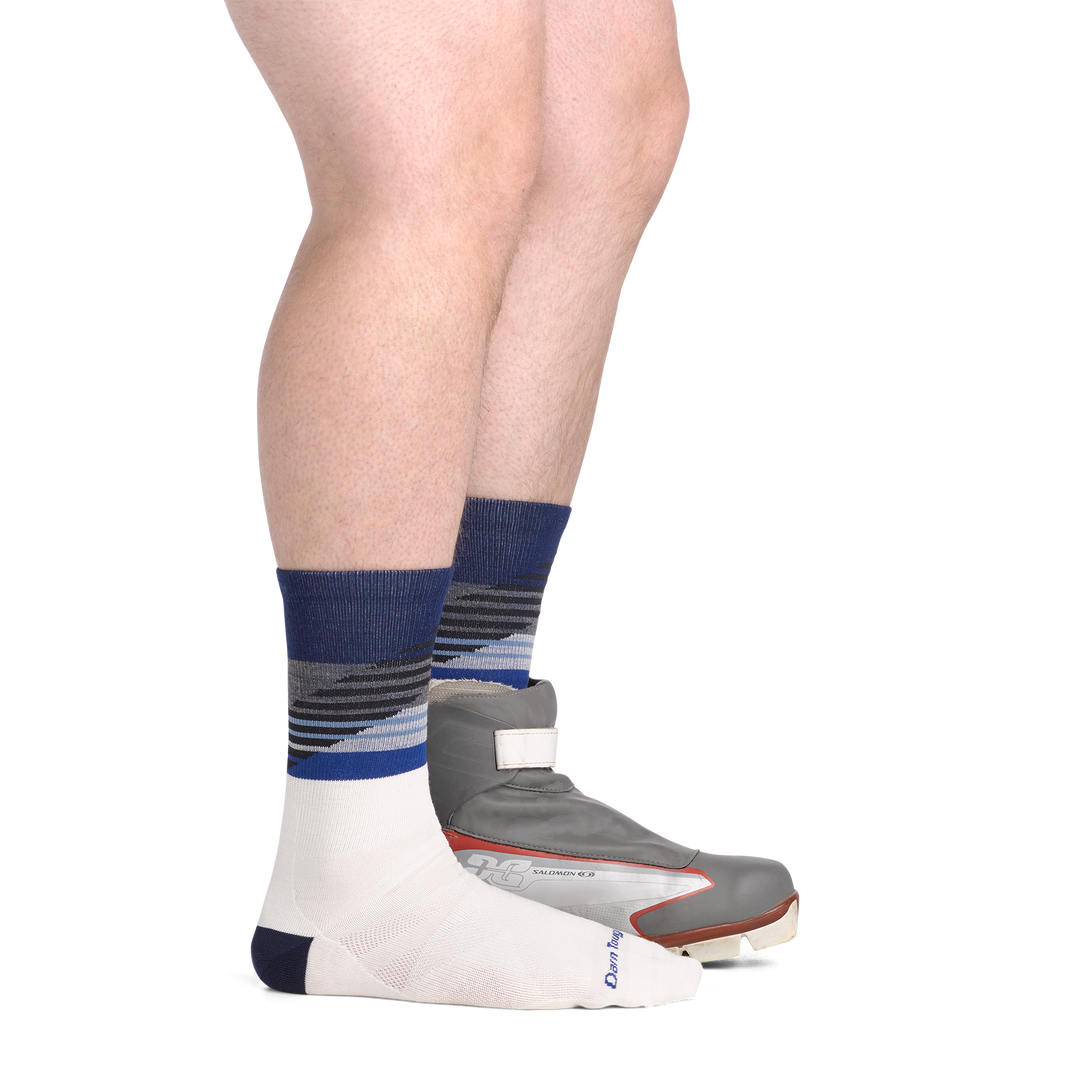 on model side view back foot in nordic boot wearing the 8032 lillehammer nordic boot sock in white colorway