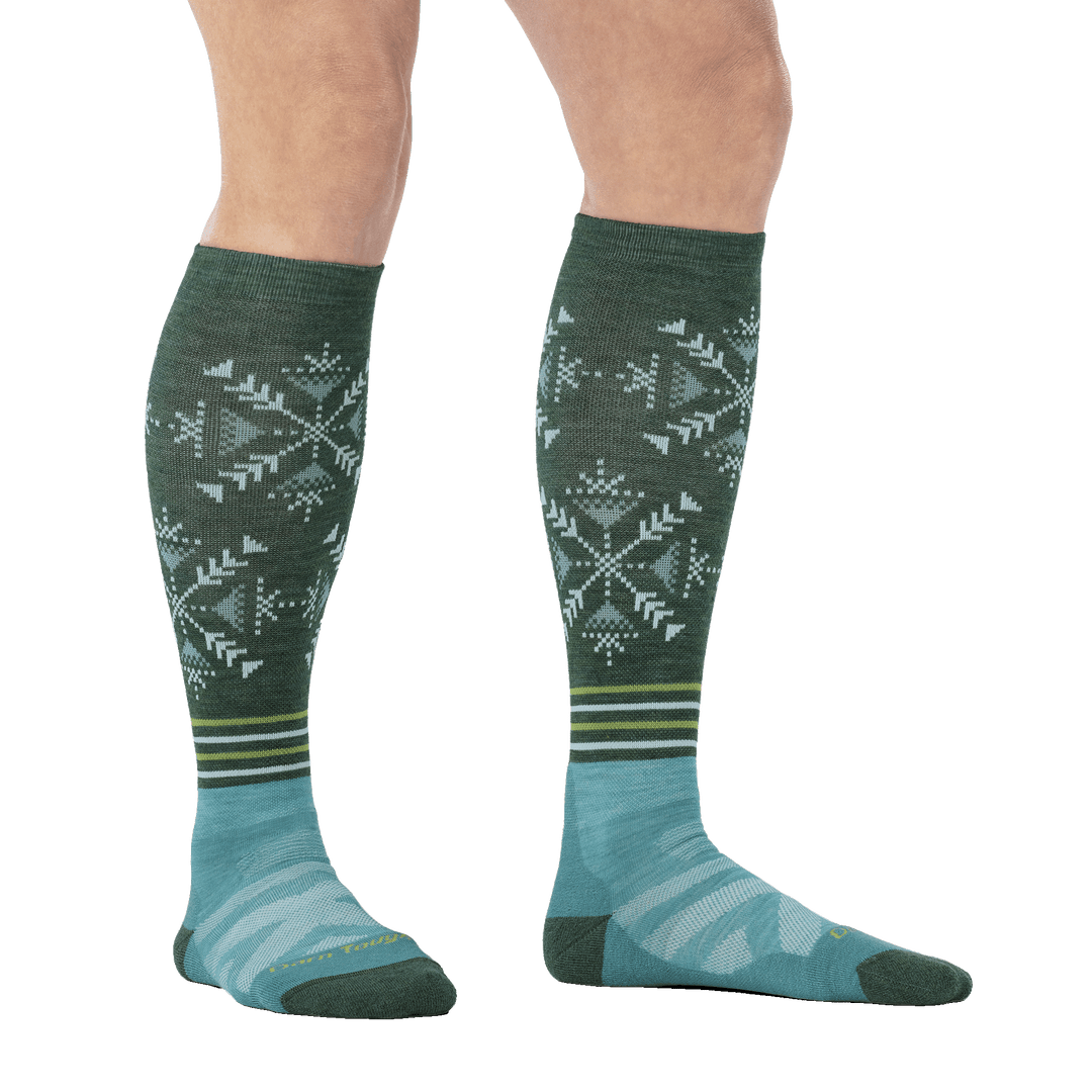 on model image studio image model wearing the snowfall over the calf ski and snowboard sock in Juniper green