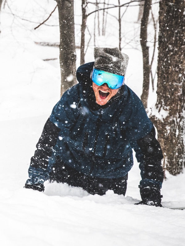 Pro snowboarder Jake Blauvelt smiling as he takes in the Vermont snow