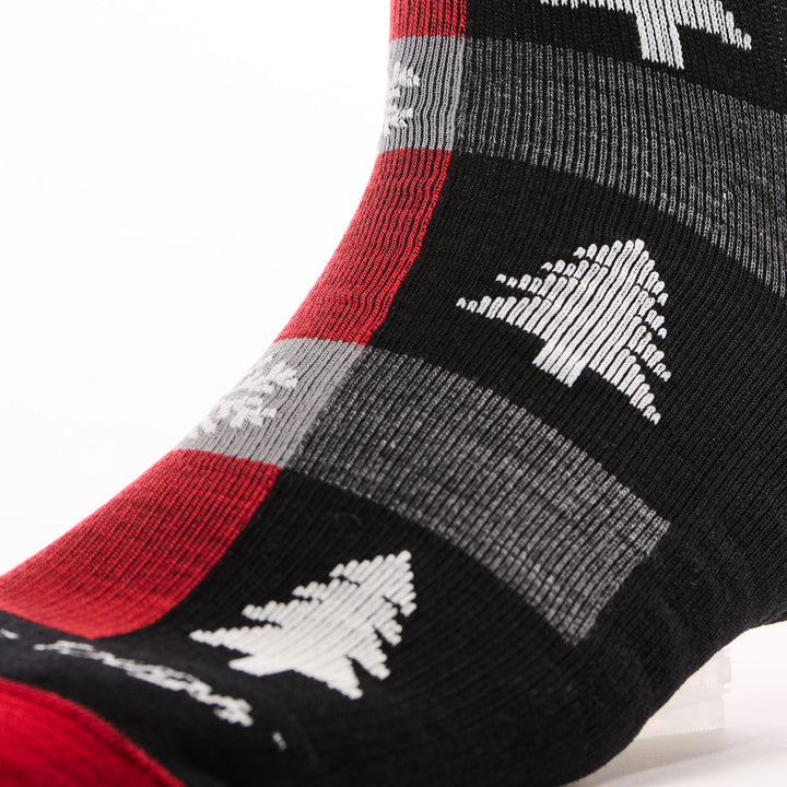 close up of unisex 6235 Festive Flannel Crew Lightweight with Cushion in coal showing flannel pattern with trees and snowflakes