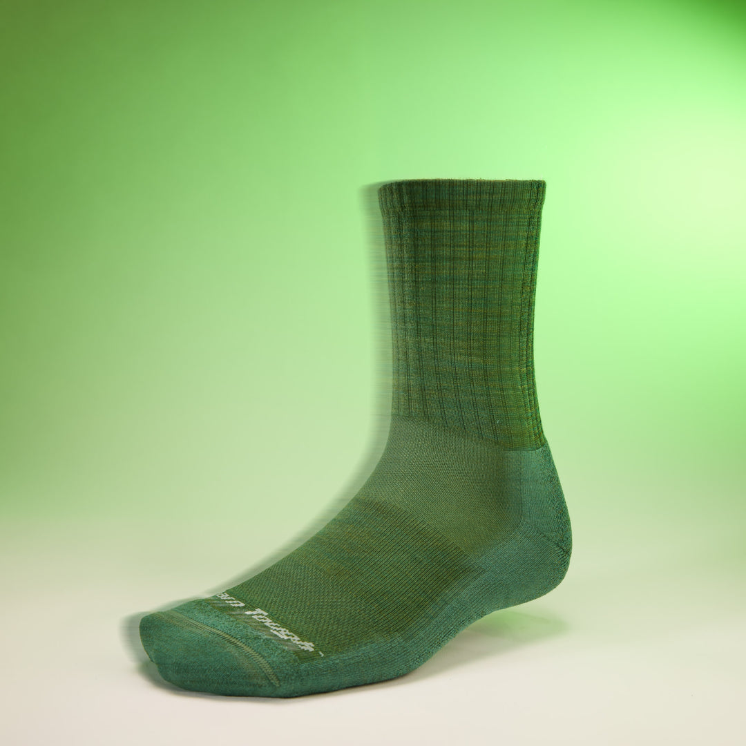 studio shot of mens 6157 the standard micro crew lightweight with cushion in moss with green background 