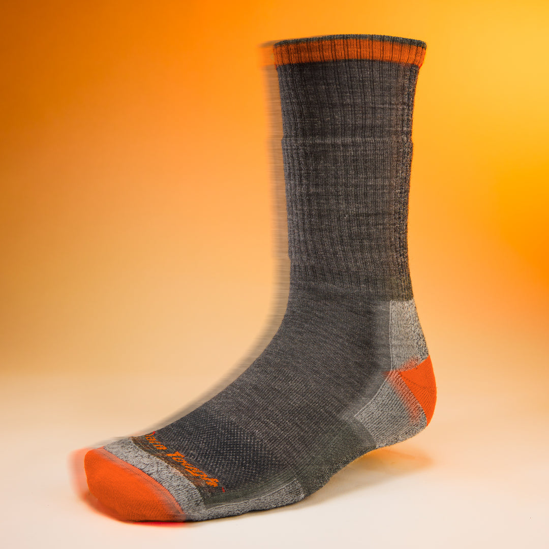 studio shot of mens 2001 John Henry Boot Midweight Cushion in iron with orange background