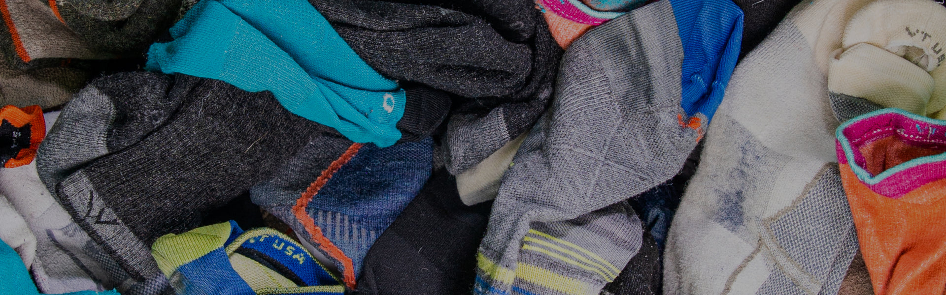 Socks with a lifetime warranty, in a big pile