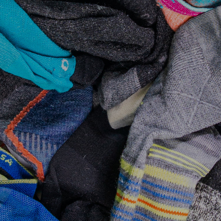 Socks with a lifetime warranty, in a big pile