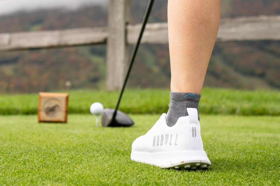 Golfer out on the green wearing darn tough athletic socks