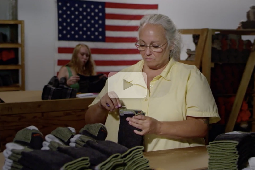 Watch Video from ABC Made in America segment. Image shows woman at Darn Tough inspecting merino wool socks