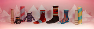 A scene straight of holiday special - snow covered mountains, cute stuffed owls, and socks, the best holiday gift idea