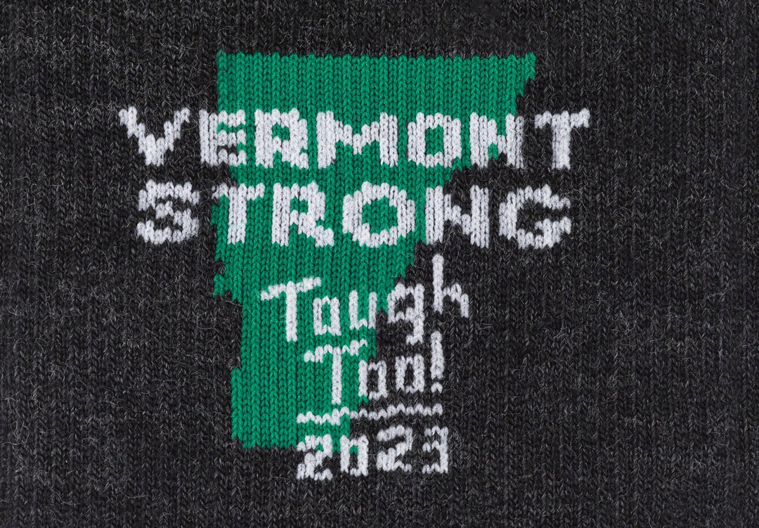 Close up on sock design, Vermont state outline with text "Vermont strong, tough too, 2023"