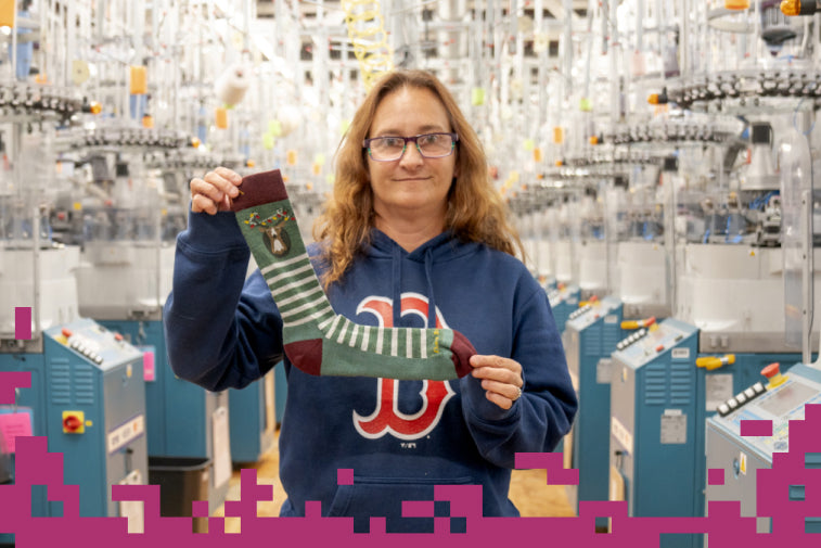 Shop Staff Picks - Darn Tough employee holding up their favorite sock to gift