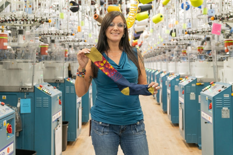 Jessica holding up her favorite sock gift idea - the Enchanted ski socks