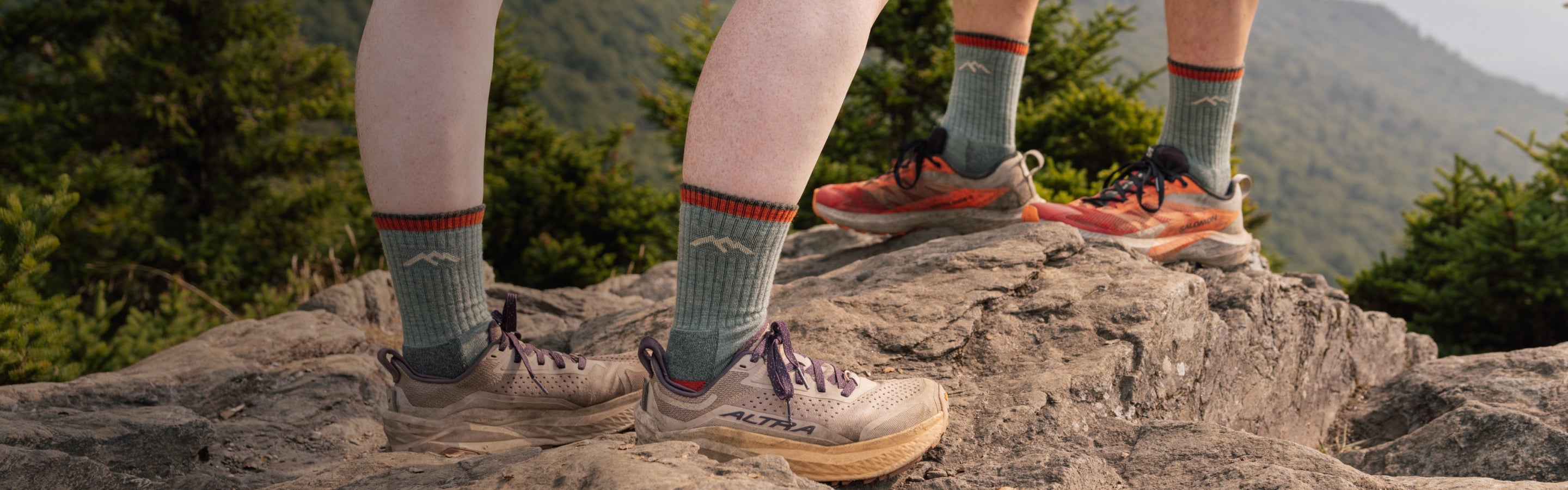 Two hikers standing on a summit wearing the 1466 hiker micro crew sock in matching colors