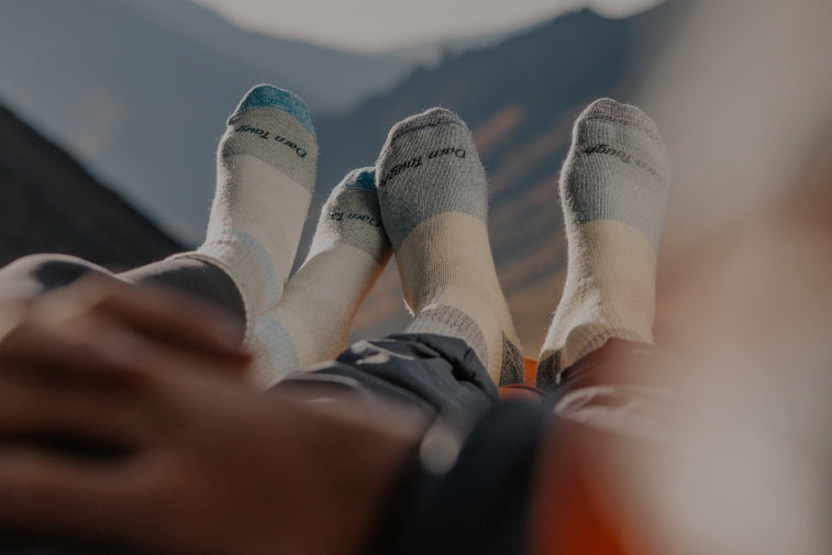 Shop Warm Socks - two pairs of feet looking very warm in matching wool socks