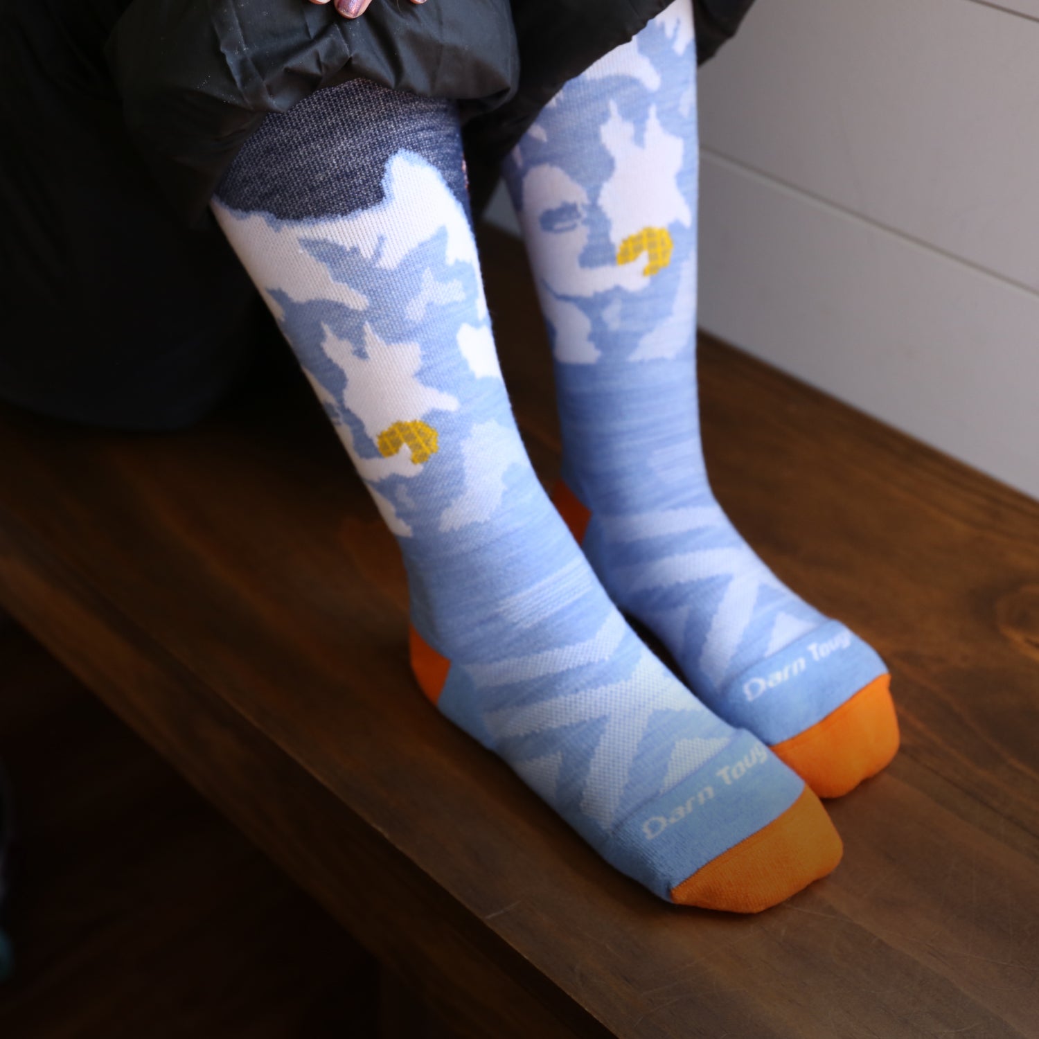 Image of model wearing the kids' little yeti over-the-calf ski sock