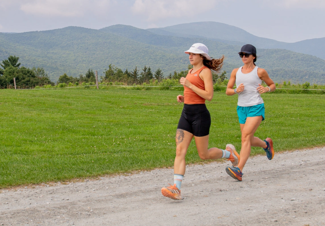 Shop Women's Running Socks - two women running down dirt road in Darn Tough run socks