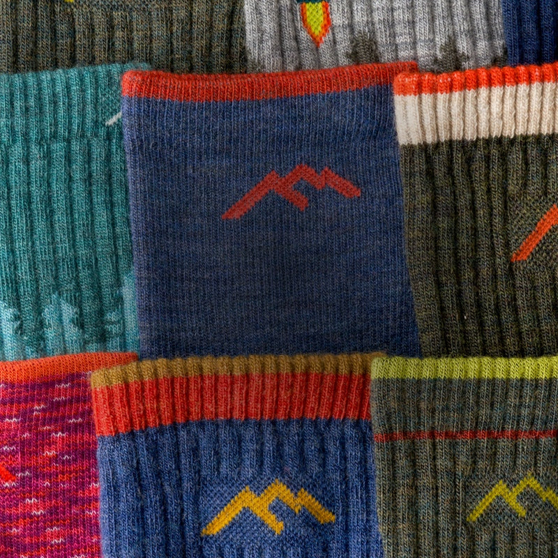 A closeup of a bunch of Darn Tough socks in different colors, all laid out