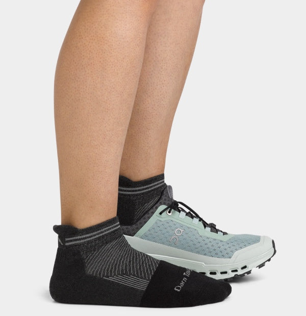 Feet wearing no show work socks with sturdy sneakers