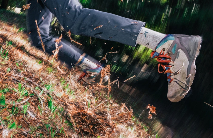 A hiker tumbling down a slope... but his Darn Tough socks are still in place